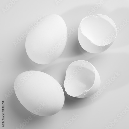Chicken eggs on a white background. Egg shell and whole chicken eggs close-up.