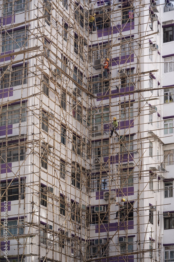 Construction workers using the tradition  bamboo scaffolders in Hong Kong 