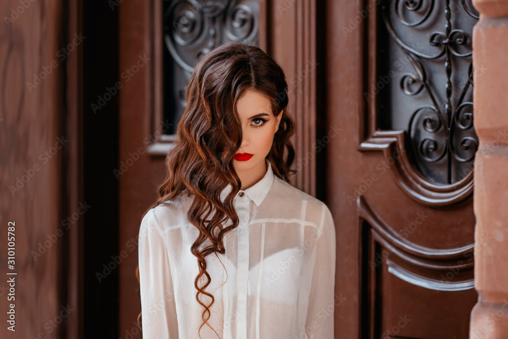 portrait of brunette girl. long hair, hairstyle curls waves Hollywood retro  style. Delicate makeup, red lips, liner eyeliner. White vintage blouse,  brown background. image prom ball graduate, teacher Stock Photo | Adobe