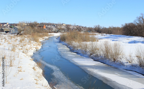 Fototapeta Naklejka Na Ścianę i Meble -  The approach of spring. On the river begins the movement of water over ice