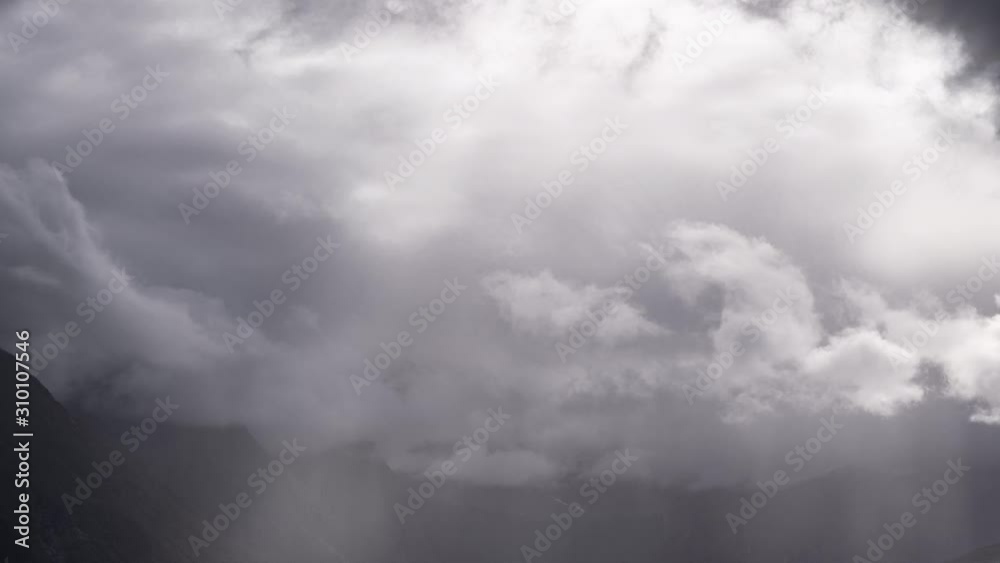 A magnificent cloudscape. Dense white clouds swirling and flowing in the valley near Andalsnes. Sunrays piercing through the clouds. A magnificent cloudscape. Dense white clouds swirling and flowing in the valley near Andalsnes. Sunrays piercing through the clouds.
