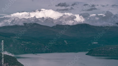 Aerial view of the clouds passing and swirling over the waters of the Innvikfjorden. A timelapse video. photo