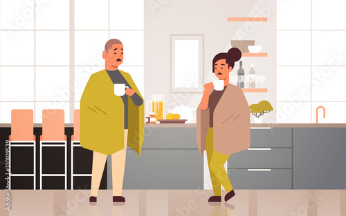 sick couple drinking hot tea unhealthy man woman covered with blanket suffering from cold flu virus illness concept modern home kitchen interior flat full length horizontal vector illustration