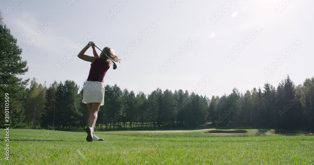 Green park, summer day, woman playing Golf, hits the ball, view of golf course in forest area, green lawn, 4k slow motion. Green park, summer day, woman playing Golf, hits the ball, view of golf course in forest area, green lawn, 4k slow motion.