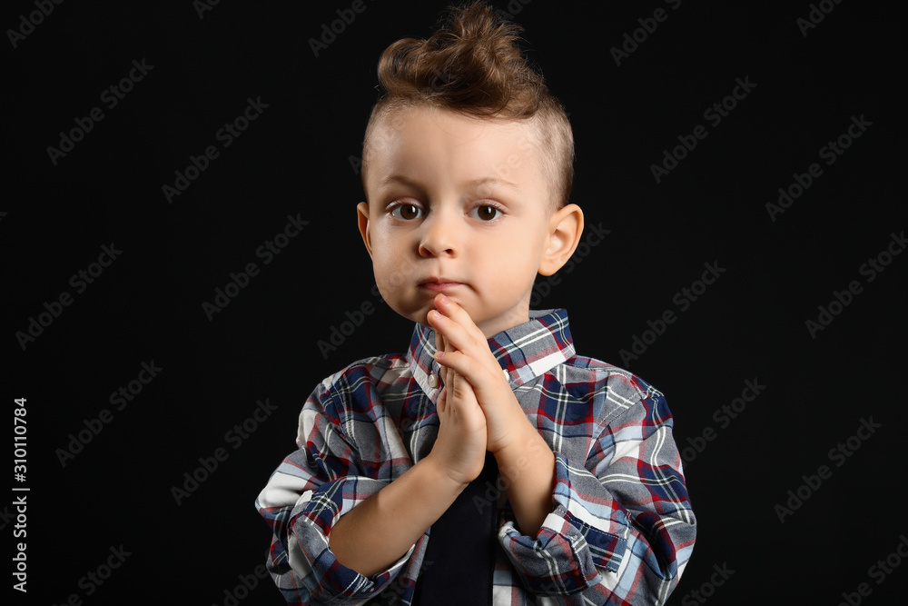 Portrait of cute little boy on dark background Portrait of cute little boy on dark background