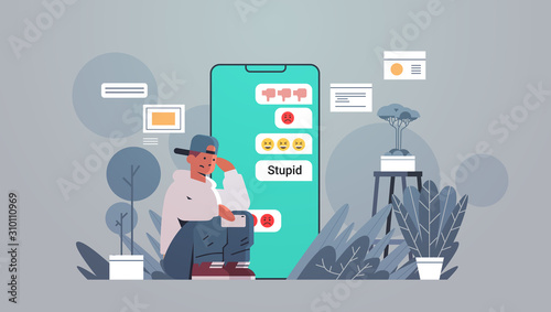 teenager being bullied guy using online mobile chat application social media harassment trolling cyber bullying concept insulting messages on smartphone screen full length flat horizontal vector © mast3r