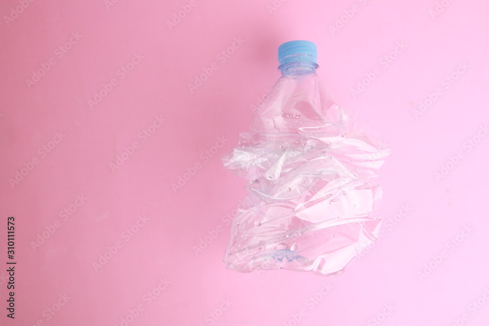 Empty plastic water bottle scaled for recycling