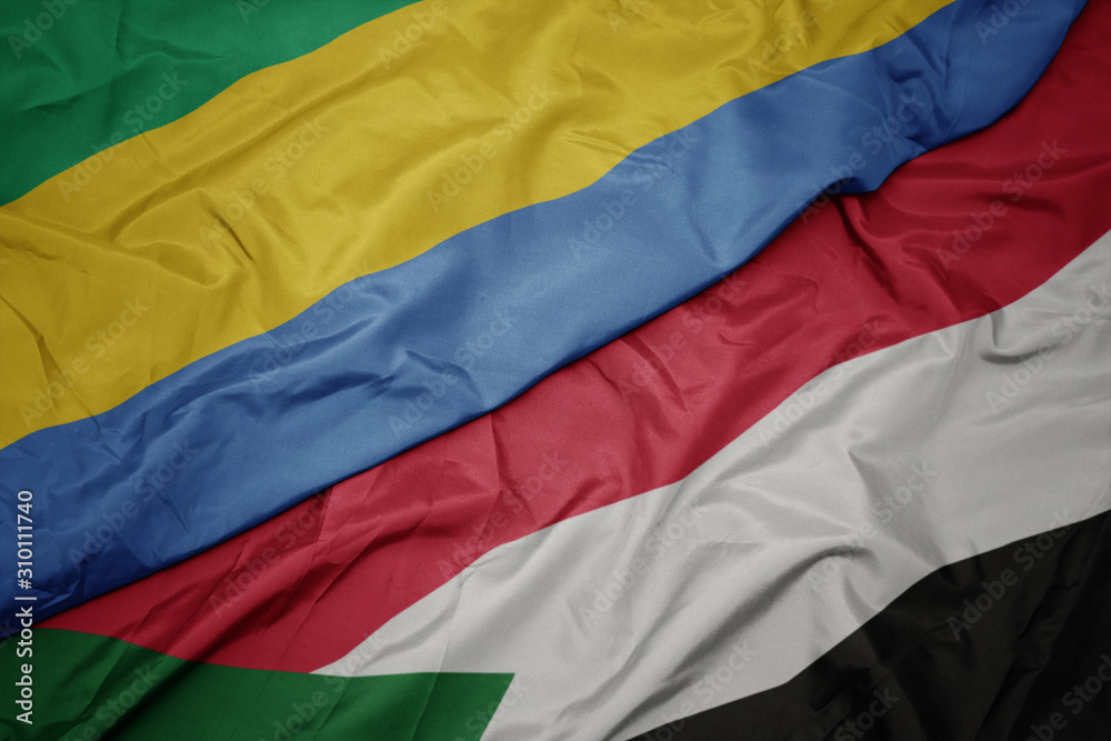 waving colorful flag of sudan and national flag of gabon. waving colorful flag of sudan and national flag of gabon.