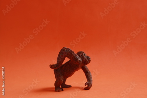orangutan shaped plastic toy in color background