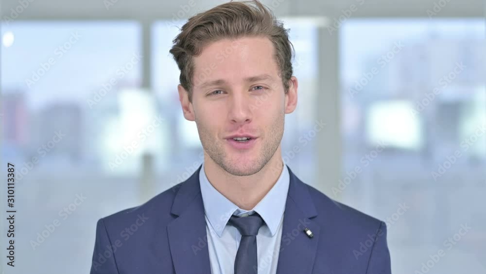 Portrait of Cheerful Young Businessman doing Video Chat Portrait of Cheerful Young Businessman doing Video Chat