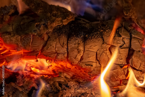 Close up shot of burning firewood in the fireplace at Christmas time