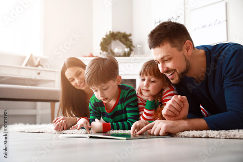 Happy family reading book a...