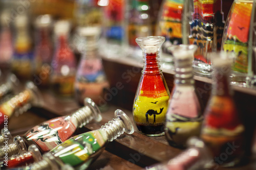 Decorative glass bottles with colored sand inside, sand souvenirs