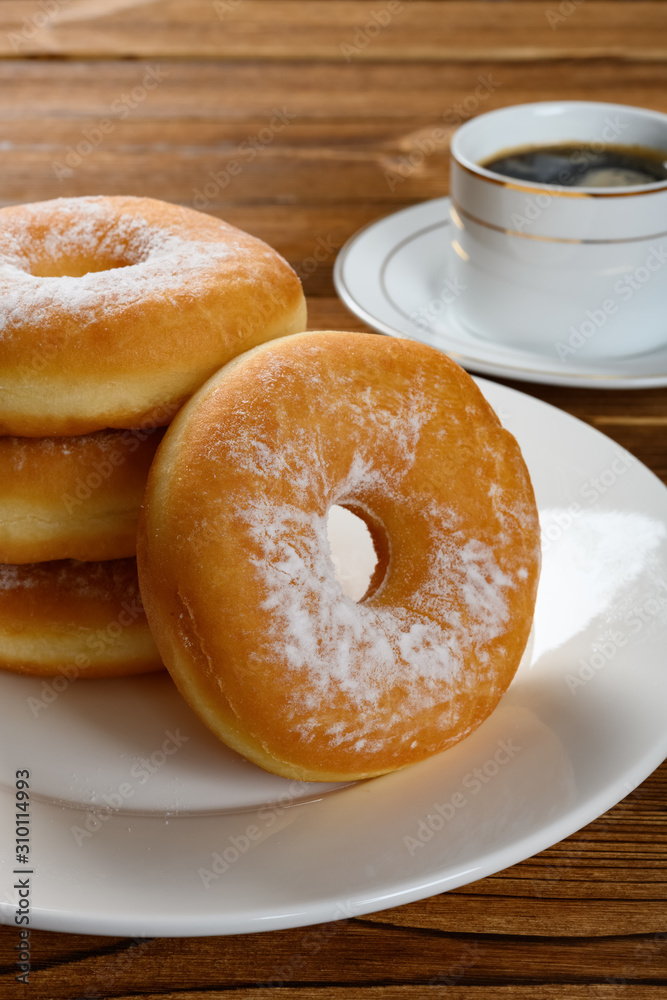donuts with cup of coffee vertical composition
