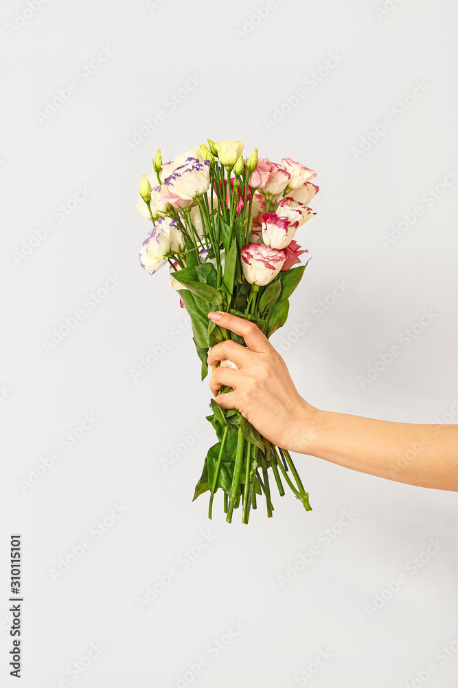 Hand of florist with beautiful bouquet on white background Hand of florist with beautiful bouquet on white background
