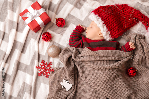 Cute little baby in Santa C...