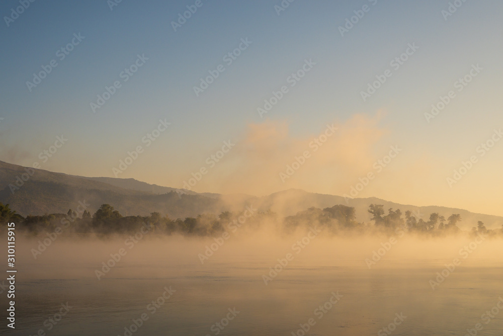 Winter morning, water vapor evaporates from the river. Amazing winter landscape.