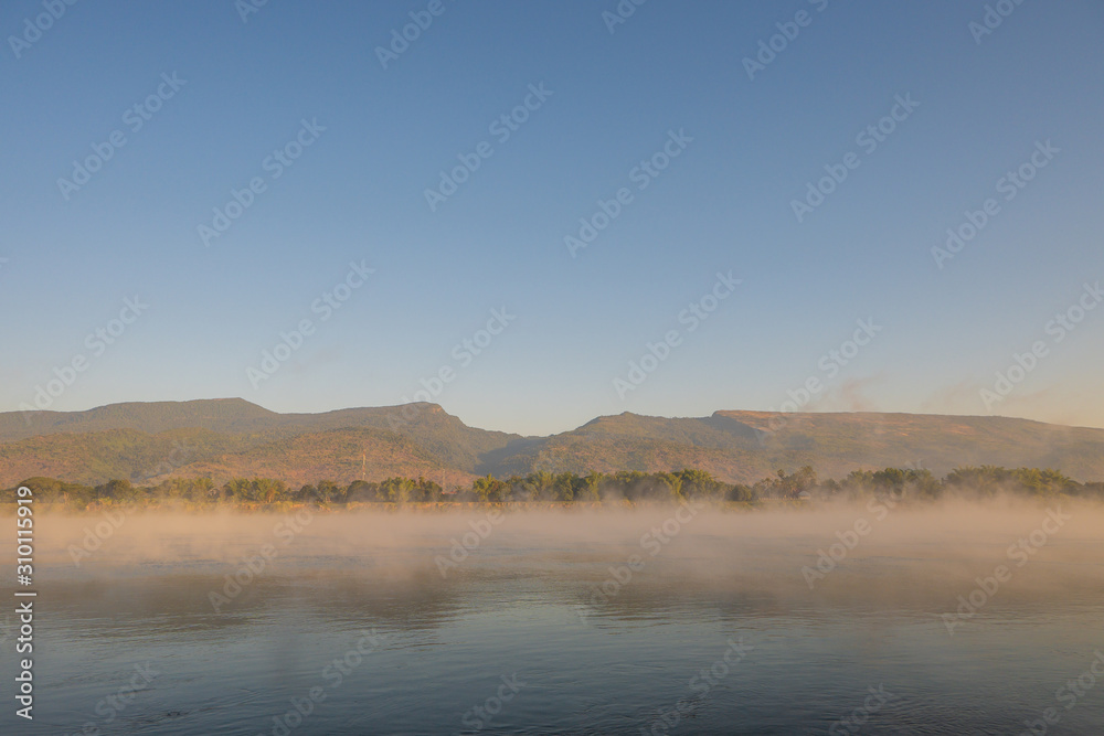 Winter morning, water vapor evaporates from the river. Amazing winter landscape. Winter morning, water vapor evaporates from the river. Amazing winter landscape.