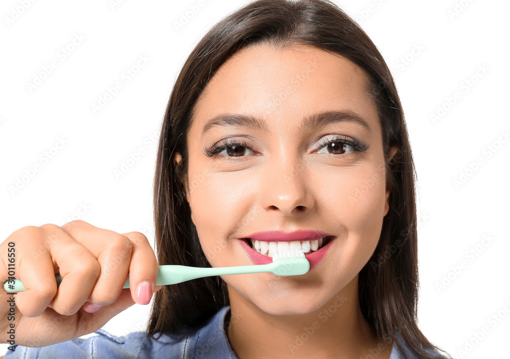 Beautiful woman brushing teeth on white background Beautiful woman brushing teeth on white background