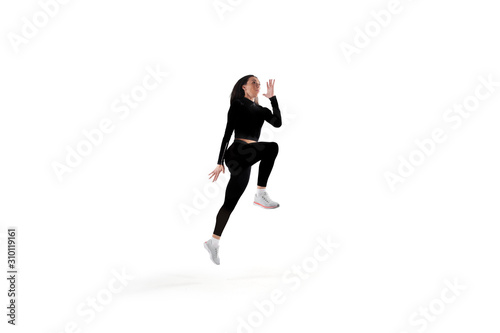 Fototapeta Naklejka Na Ścianę i Meble -  Female athlete running and jumping isolated on white.