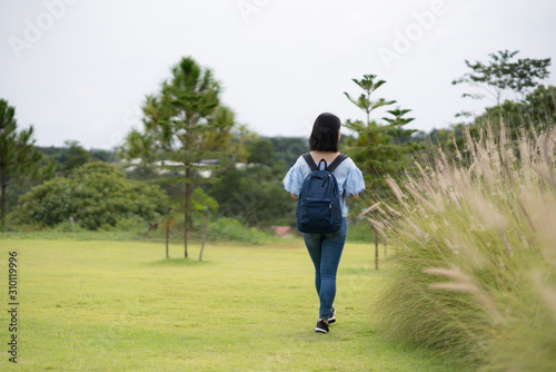 young cute Japanese Asian hipster girl travelling at beautiful sky mountains scenery park hiking garden views at Kanchanaburi Thailand guiding idea for female backpacker woman women backpacking