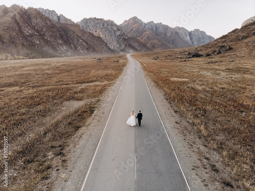 Newlyweds are walking on the road