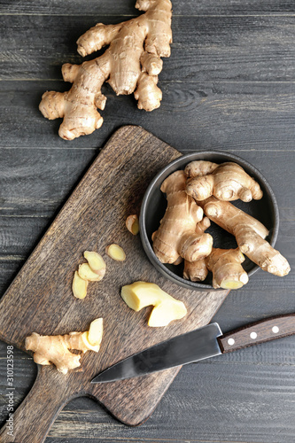 Cutting board with fresh ginger on wooden table