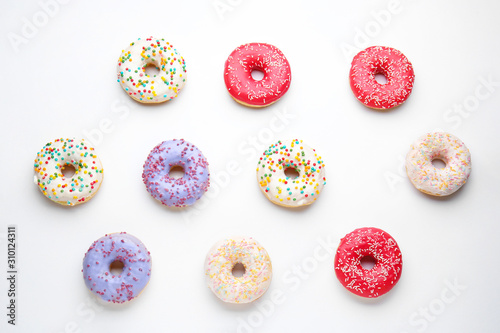 Sweet tasty donuts on white background