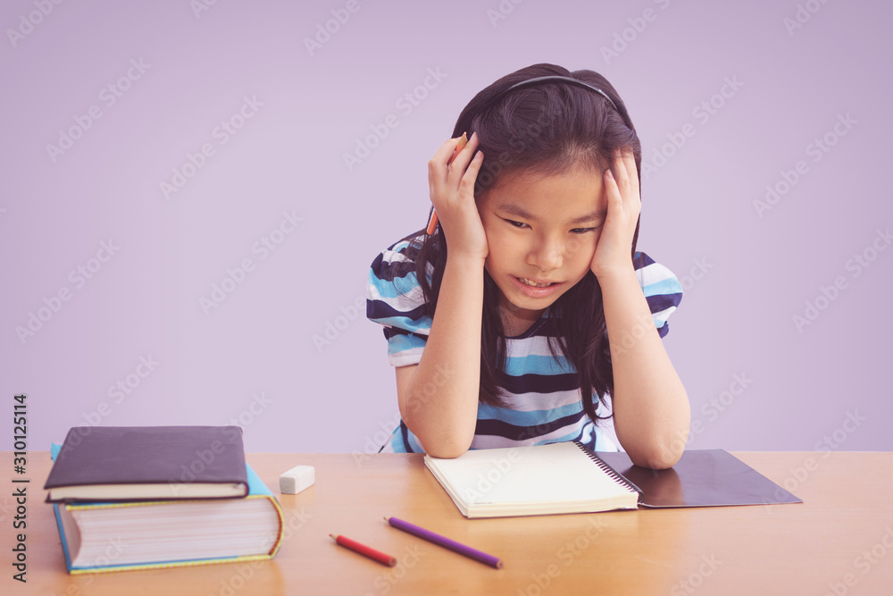 Bored and tired asian student girl doing homework Bored and tired asian student girl doing homework