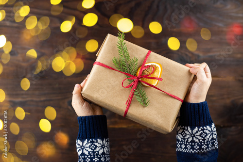 Craft gift in childres hands on wooden background photo