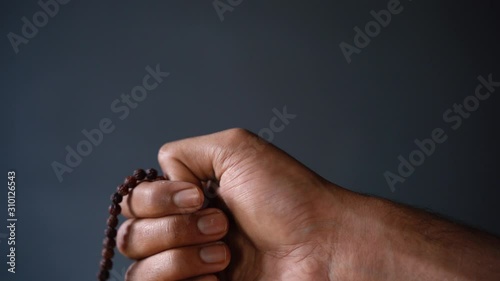 chanting mantra with japa mala close up photo