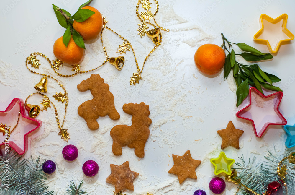 Christmas or X-mas baking culinary background, cooking recipe. Xmas, Noel gingerbread cookies on kitchen table and ingredients. For festive baking. New Year Christmas or X-mas baking culinary background, cooking recipe. Xmas, Noel gingerbread cookies on kitchen table and ingredients. For festive baking. New Year