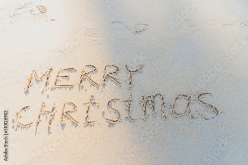 Concept Christmas on the beach Tropical design made in Phuket, Thailand Write the alphabet on the sand background Taken from real locations. © Stock.Foto.Touch