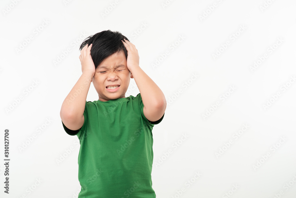 Cute boy suffering from headache on white background Cute boy suffering from headache on white background