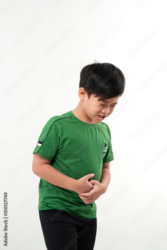 Child standing in profile having a severe stomach ache and screaming isolated on white background Child standing in profile having a severe stomach ache and screaming isolated on white background