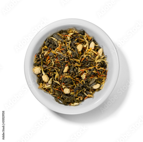 Green tea with aromatic additives. Top view on white background