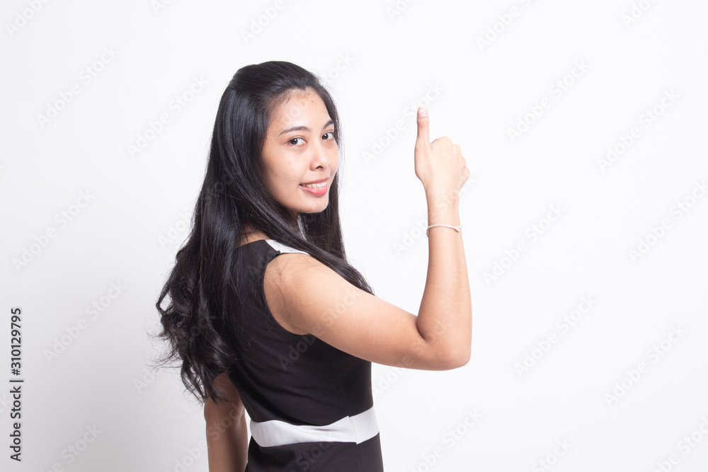 Young Asian woman turn back thumbs up Young Asian woman turn back thumbs up