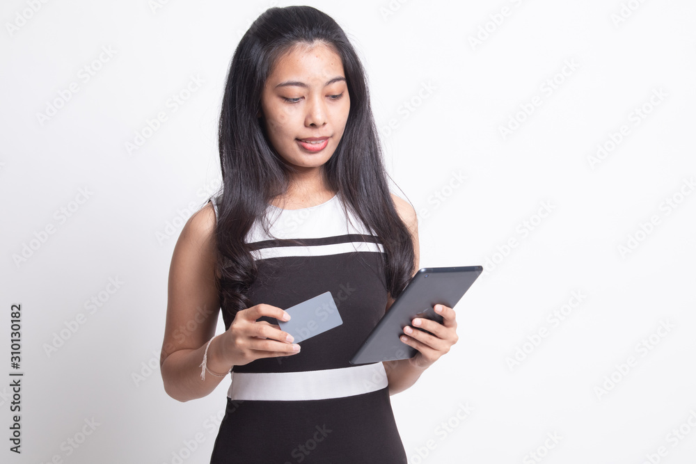 Young Asian woman is shopping online with credit card and tablet Young Asian woman is shopping online with credit card and tablet