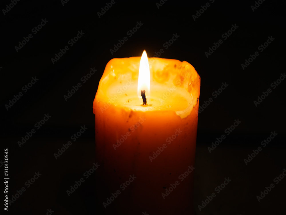 Candle on a dark background. Burning candle during the festival of light. Candle in the dark background. Candle on a dark background. Burning candle during the festival of light. Candle in the dark background.