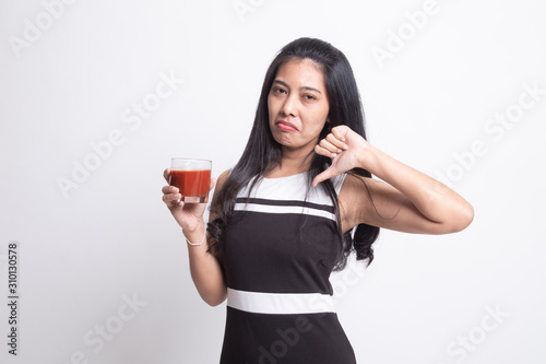 Asian woman thumbs down hate tomato juice