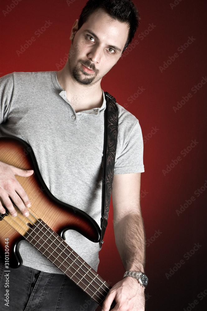 bass guitarist and red background