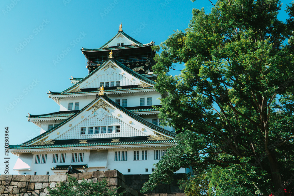 Osaka castle through the trees