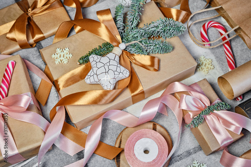 Christmas presents packing on the table. Happy holiday, gift box close-up. Surprise for Boxing day, Christmas and New Year party. Magic time. Celebration winter event. Wrapping paper, toys and ribbon