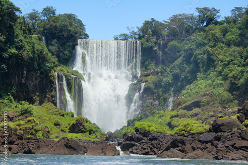 Spectacular view on famous Argentina nature landmark - Iguazu Waterfalls. Beautiful cascades of water - Devils Throat - attracting millions of tourists every year. Unesco world heritage site. 