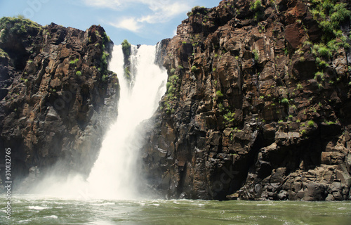 Spectacular view on famous Argentina nature landmark - Iguazu Waterfalls. Beautiful cascades of water - Devils Throat - attracting millions of tourists every year. Unesco world heritage site. 