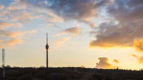 Germany, Famous stuttgart city television tower surrounded by forest in autumn mood decorated by orange sunset sky