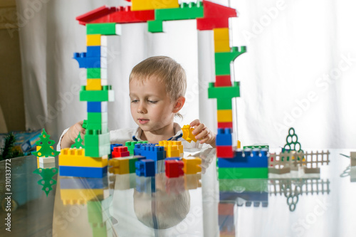 little boy playing with building blocks
