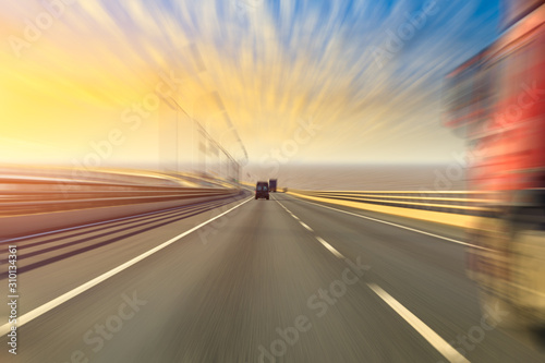 Blurred motion of truck and asphalt road at dusk