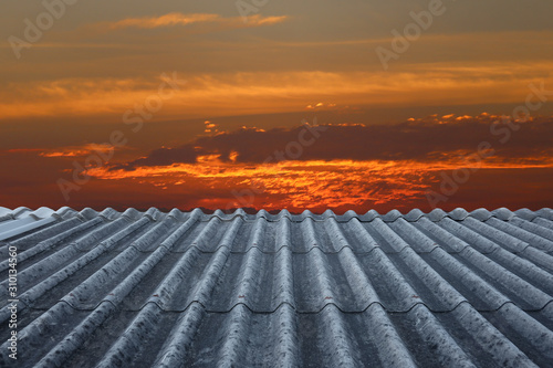Old tile roofs and the backdrop of the sunset.