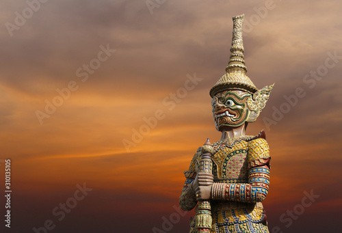 Statues of giants in Thai literature on sunset background.